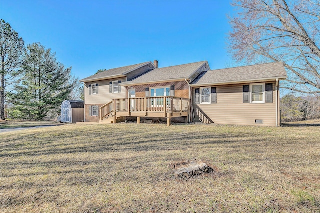 back of house featuring a wooden deck, a lawn, and a storage shed