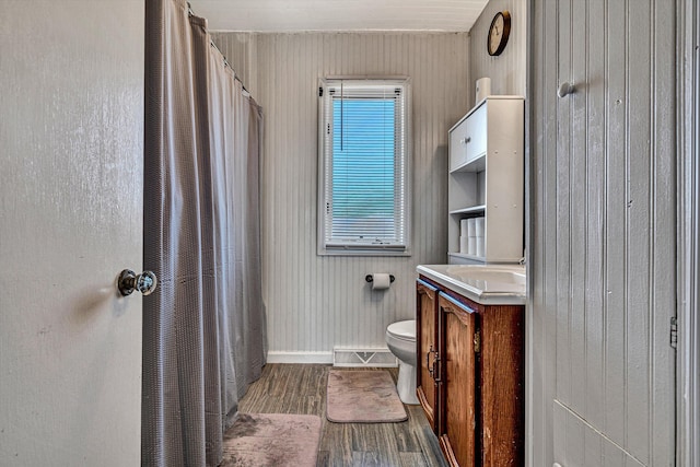 bathroom featuring vanity, hardwood / wood-style flooring, and toilet