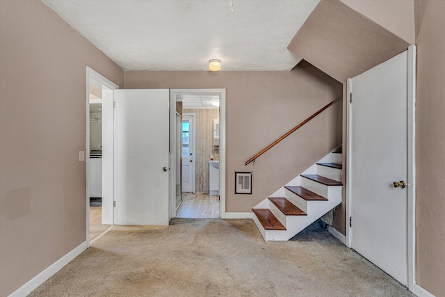 entrance foyer featuring light carpet