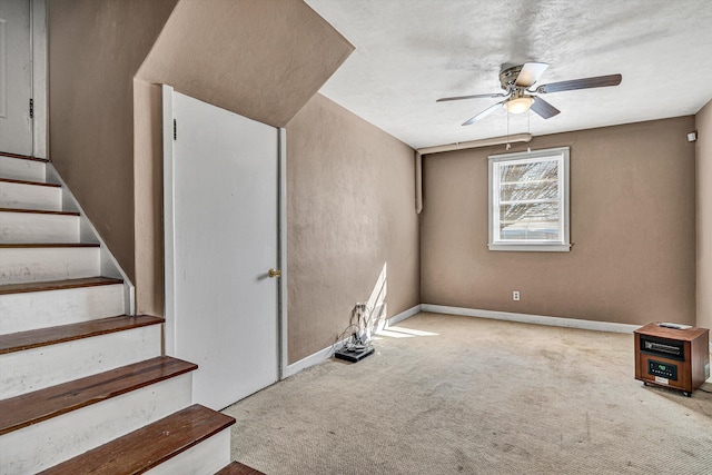 interior space with ceiling fan and carpet flooring