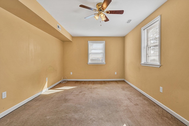 spare room with light colored carpet and ceiling fan