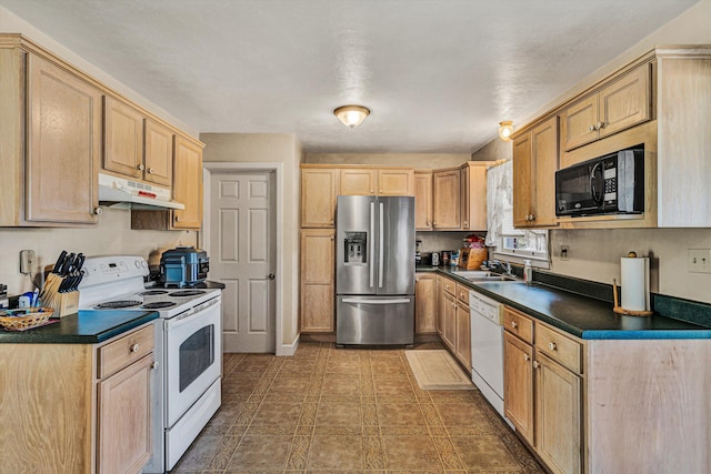 kitchen featuring white appliances, sink, and light brown cabinets