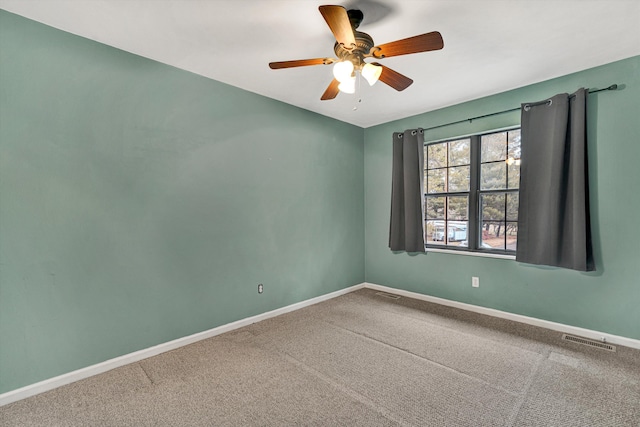 carpeted empty room featuring ceiling fan