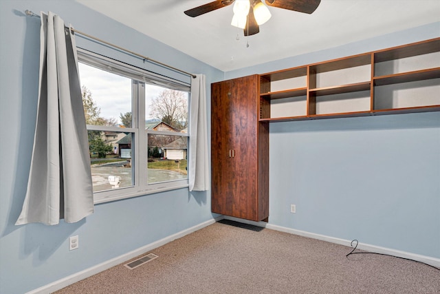 unfurnished bedroom featuring light carpet and ceiling fan