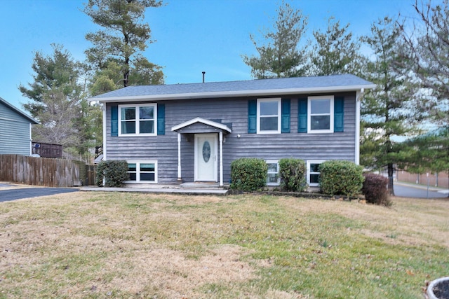 split foyer home with a front lawn