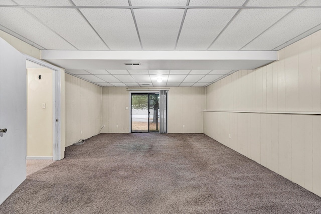 spare room with carpet flooring and a drop ceiling