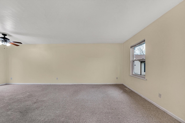 carpeted spare room featuring ceiling fan