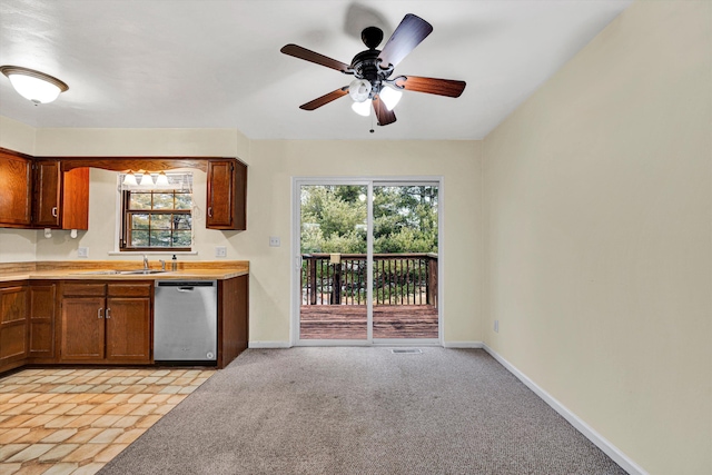 kitchen featuring dishwasher, sink, light colored carpet, and ceiling fan