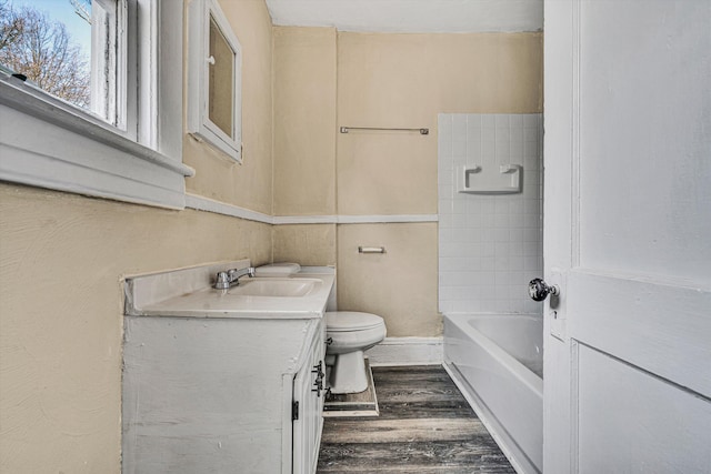 full bath with wood finished floors, toilet, and vanity