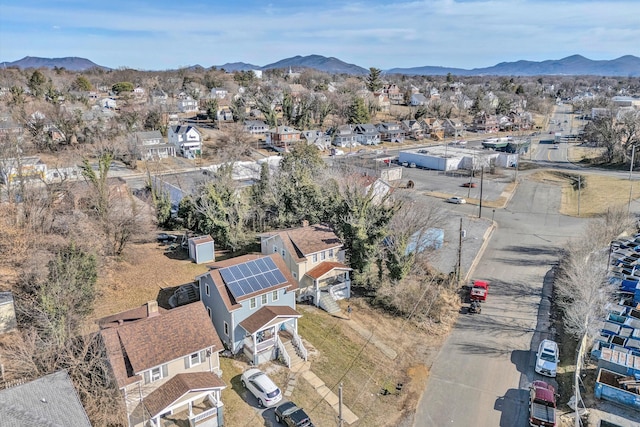 aerial overview of property's location featuring a mountain backdrop and nearby suburban area