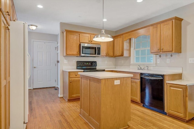 kitchen with a kitchen island, pendant lighting, light hardwood / wood-style floors, and black appliances