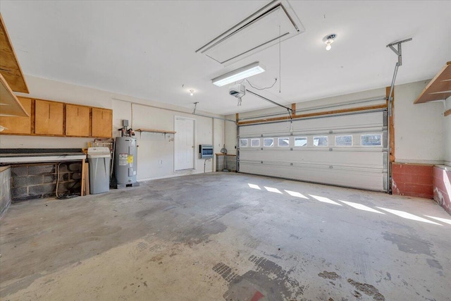 garage featuring a garage door opener and electric water heater