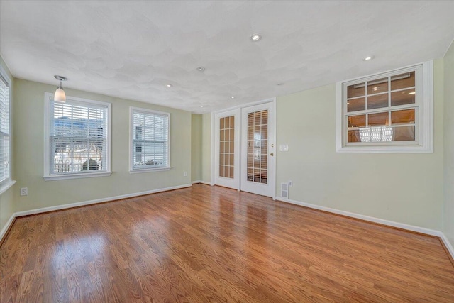 unfurnished room with hardwood / wood-style floors