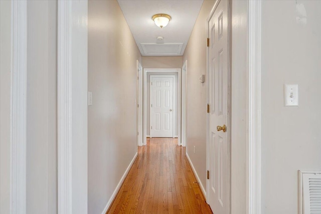 hallway with light hardwood / wood-style flooring