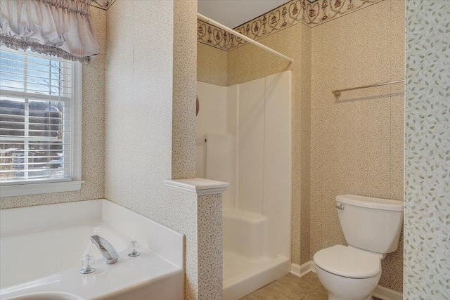 bathroom featuring tile patterned flooring, toilet, and separate shower and tub