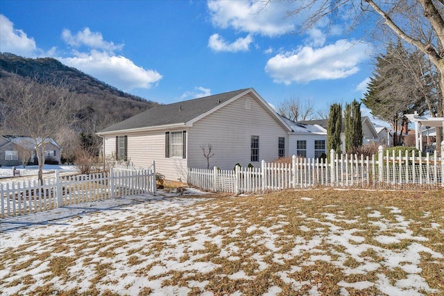 view of snow covered exterior with a mountain view