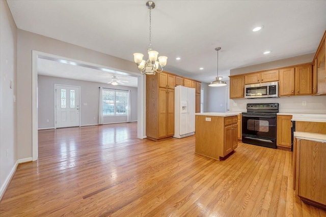 kitchen with black electric range oven, hanging light fixtures, a kitchen island, white fridge with ice dispenser, and light hardwood / wood-style floors