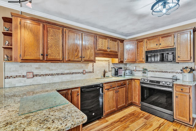 kitchen with black appliances, sink, ornamental molding, light hardwood / wood-style floors, and light stone counters