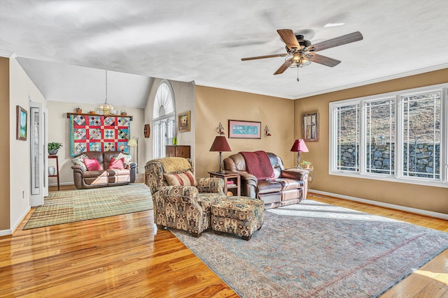 living room featuring crown molding, lofted ceiling, ceiling fan, and light hardwood / wood-style floors