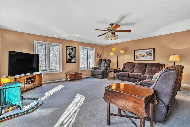 carpeted living room with ceiling fan