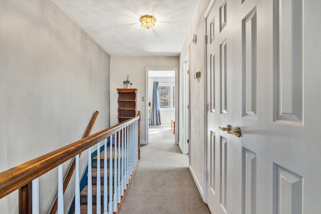 hallway featuring light colored carpet