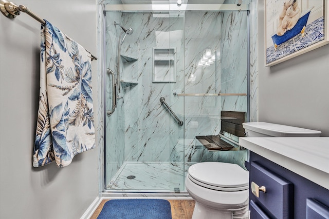 bathroom featuring vanity, hardwood / wood-style floors, toilet, and walk in shower