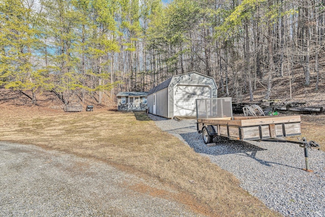 view of yard featuring a garage and an outdoor structure