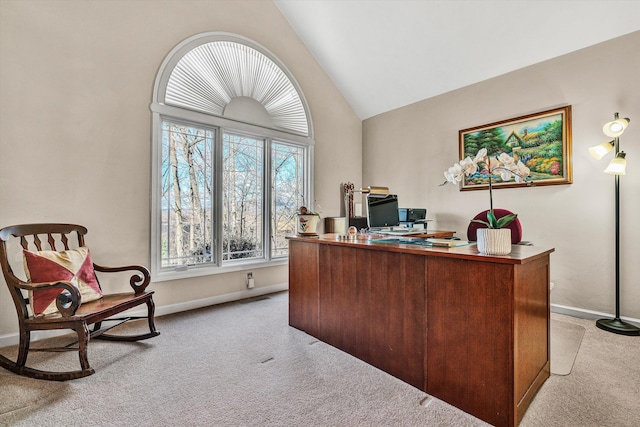 carpeted home office featuring lofted ceiling