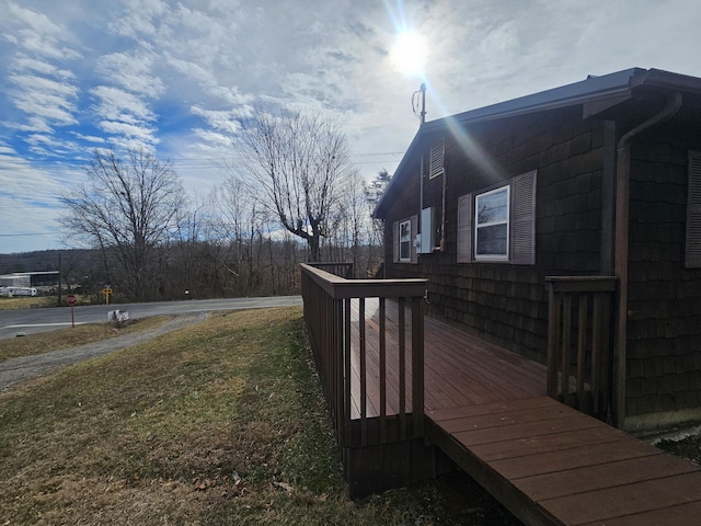 view of home's exterior featuring a wooden deck and a yard