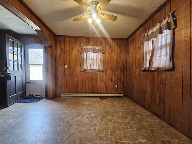 empty room with ceiling fan, a baseboard radiator, ornamental molding, and wooden walls