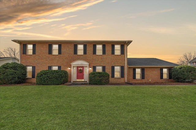 colonial-style house with a yard