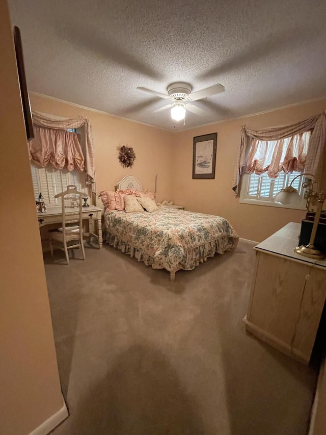 bedroom featuring ceiling fan, carpet floors, and a textured ceiling