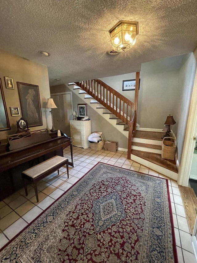 interior space featuring tile patterned flooring and a textured ceiling