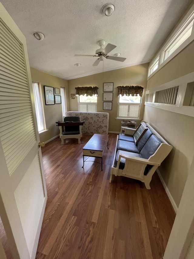 living room with ceiling fan, wood-type flooring, a textured ceiling, and plenty of natural light