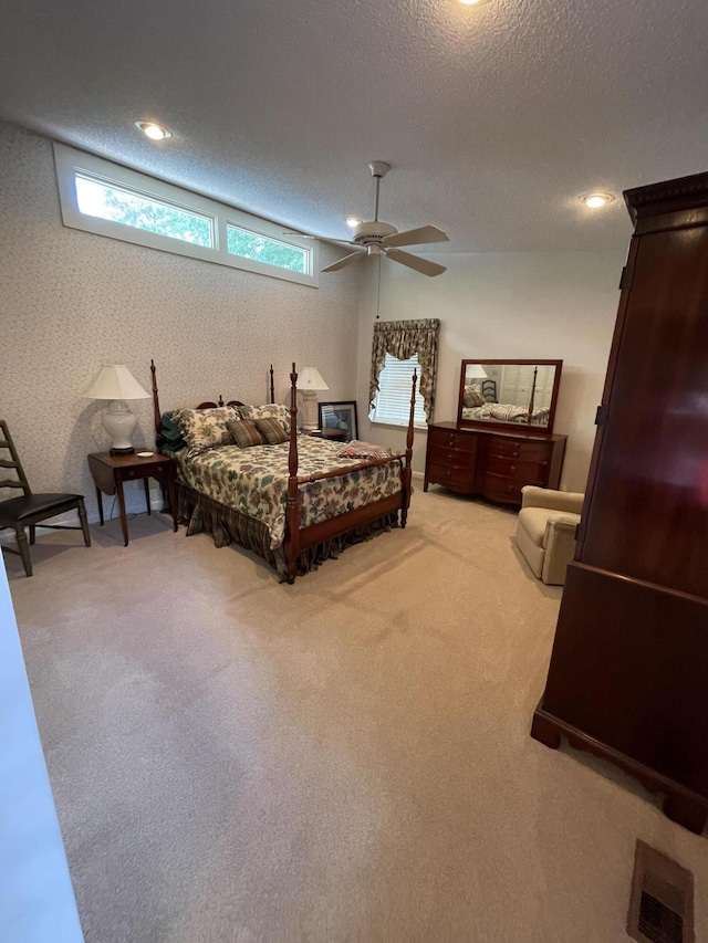 bedroom with ceiling fan, a textured ceiling, and carpet flooring