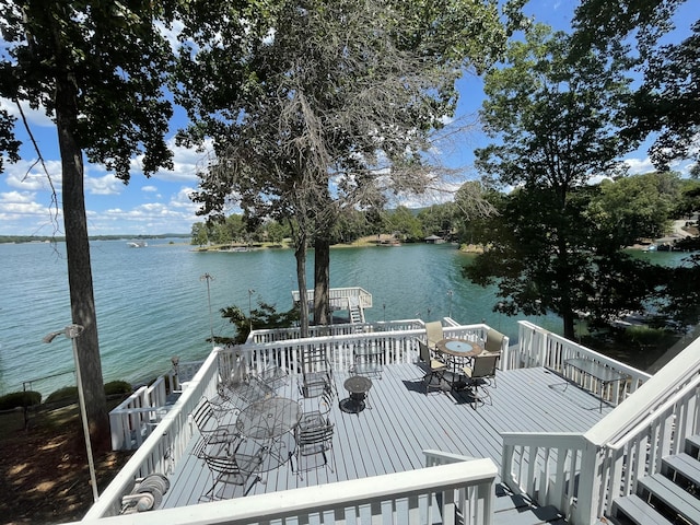 view of dock with a deck with water view