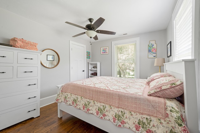 bedroom with dark hardwood / wood-style flooring and ceiling fan