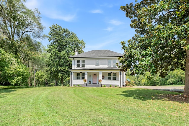 view of front of house featuring a front lawn and covered porch