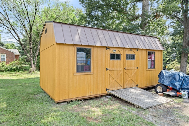 view of outbuilding featuring a lawn