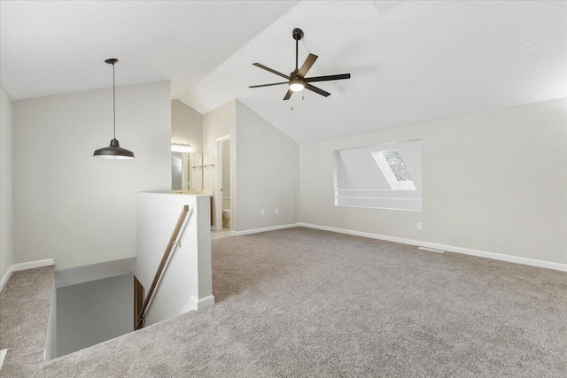 unfurnished living room featuring ceiling fan, carpet flooring, and vaulted ceiling