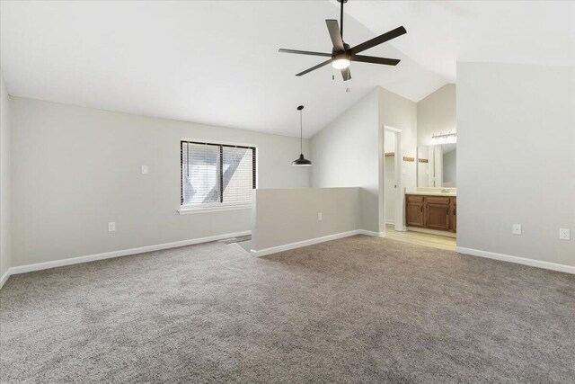 unfurnished room featuring lofted ceiling, light carpet, and ceiling fan