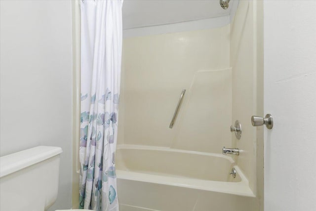 bathroom with shower / bath combination with curtain and toilet