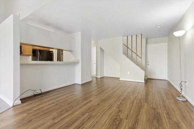 unfurnished living room featuring hardwood / wood-style floors