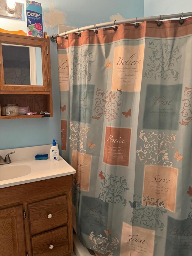 bathroom with vanity and a shower with shower curtain