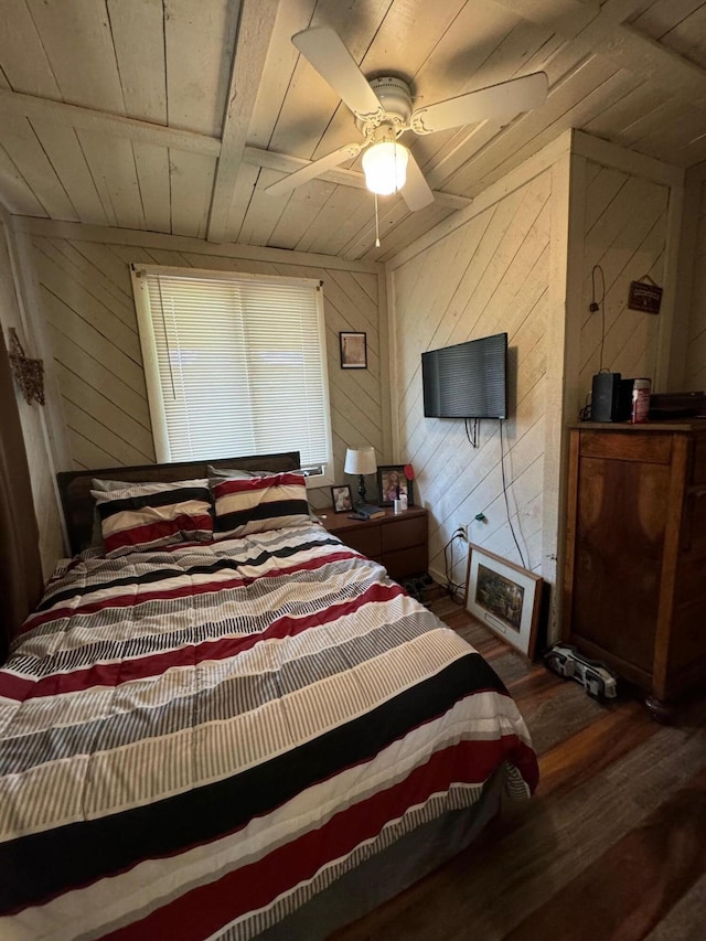 bedroom with ceiling fan, wooden ceiling, dark hardwood / wood-style flooring, and wood walls