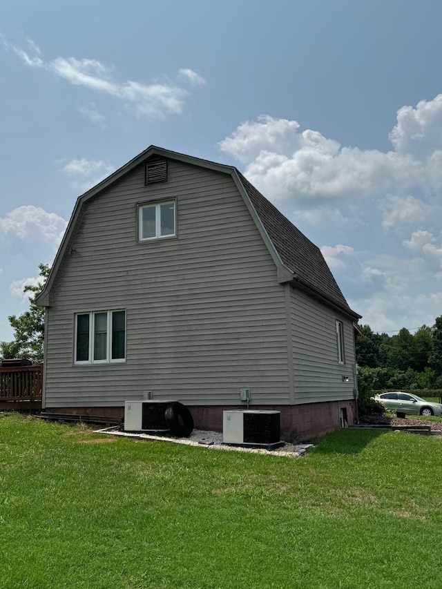 view of home's exterior featuring central AC and a yard