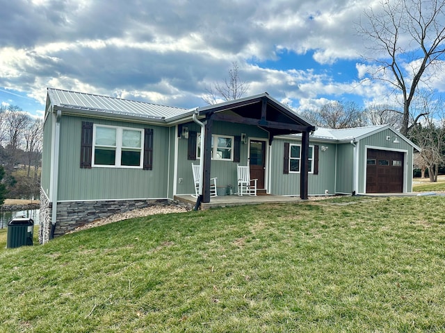 view of front of property featuring a garage, covered porch, and a front lawn