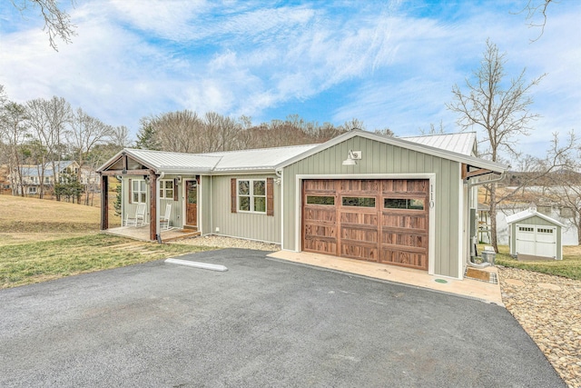 ranch-style house featuring a garage and covered porch