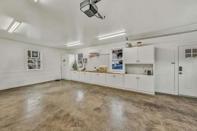 garage featuring a wall unit AC