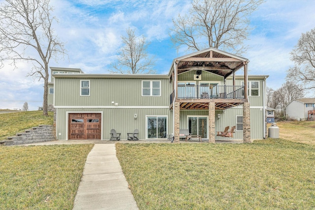 rear view of house with a garage and a lawn